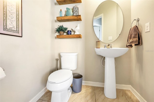 bathroom featuring toilet and tile patterned flooring