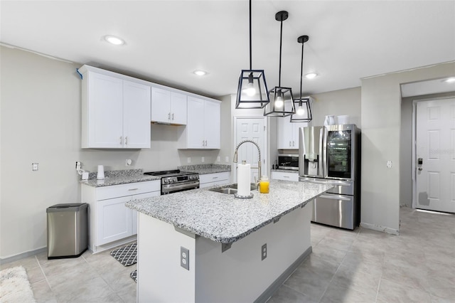 kitchen featuring white cabinetry, sink, an island with sink, and stainless steel appliances