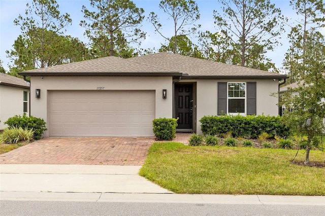 view of front of property with a garage and a front yard