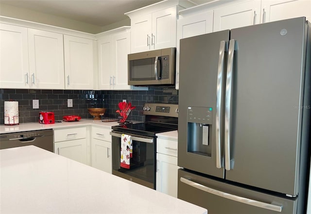 kitchen featuring white cabinets, stainless steel appliances, and backsplash