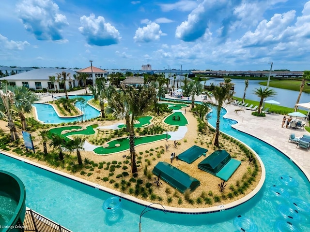 view of swimming pool with a water view and a patio area