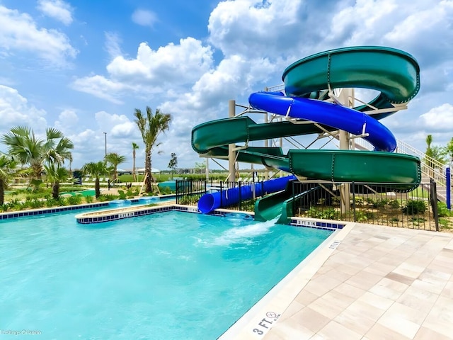 view of swimming pool with a water slide