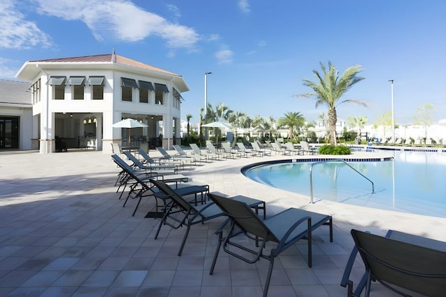 view of swimming pool featuring a patio area