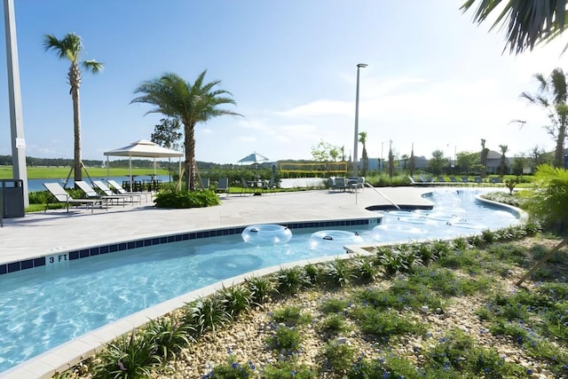 view of swimming pool featuring a water view