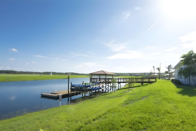 dock area with a water view and a yard