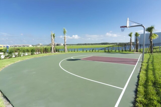 view of sport court featuring a water view