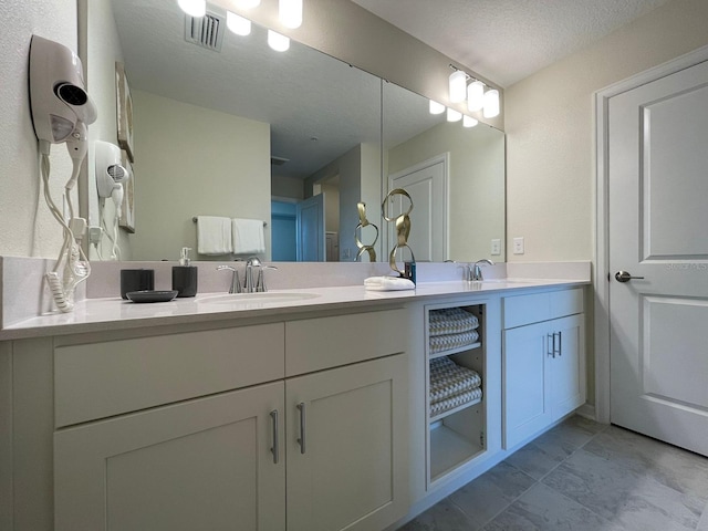 bathroom featuring vanity and a textured ceiling