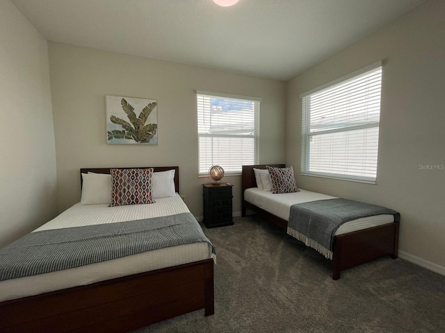 bedroom featuring dark colored carpet