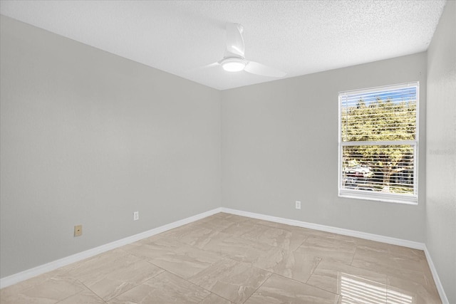 empty room featuring ceiling fan and a textured ceiling