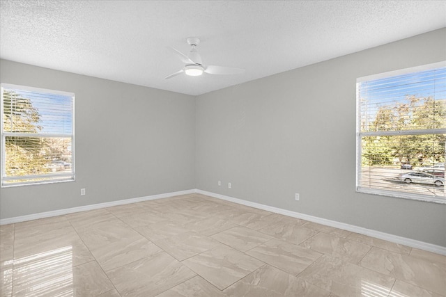 unfurnished room featuring ceiling fan and a textured ceiling