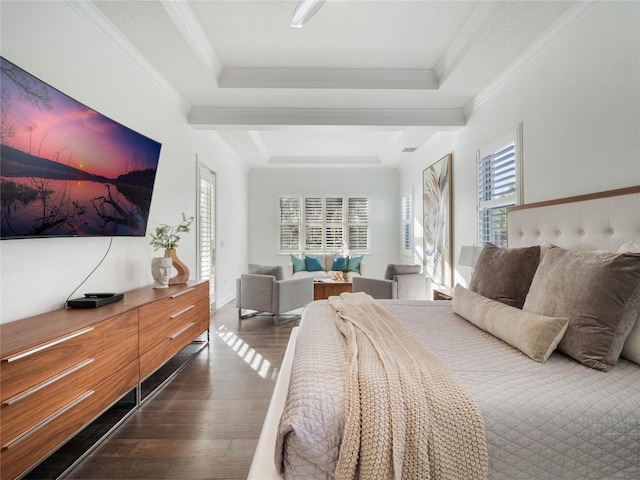 bedroom featuring dark wood-type flooring, crown molding, and a tray ceiling