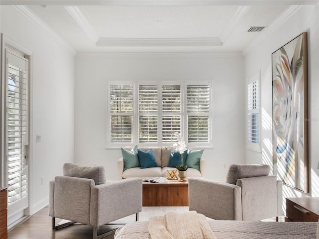 living room with plenty of natural light, light hardwood / wood-style flooring, and crown molding