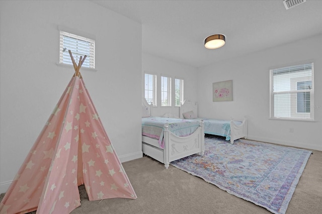 carpeted bedroom featuring multiple windows