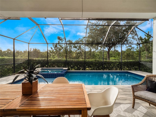 view of pool featuring a patio, a lanai, and an in ground hot tub