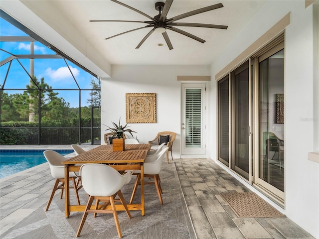 sunroom featuring a swimming pool and ceiling fan