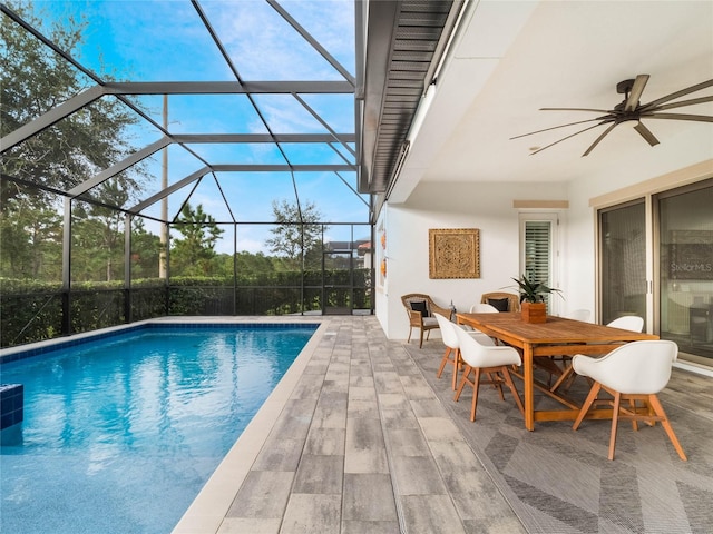 view of swimming pool featuring a patio area, a lanai, and ceiling fan