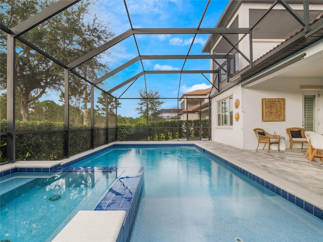 view of swimming pool with a lanai and a patio area