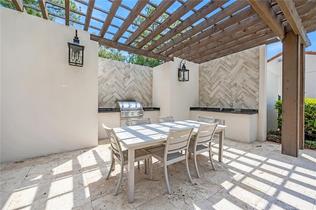 view of patio / terrace with area for grilling and a pergola