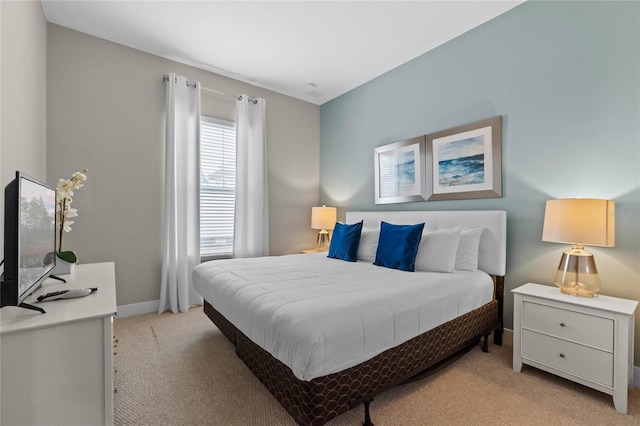 bedroom featuring light carpet