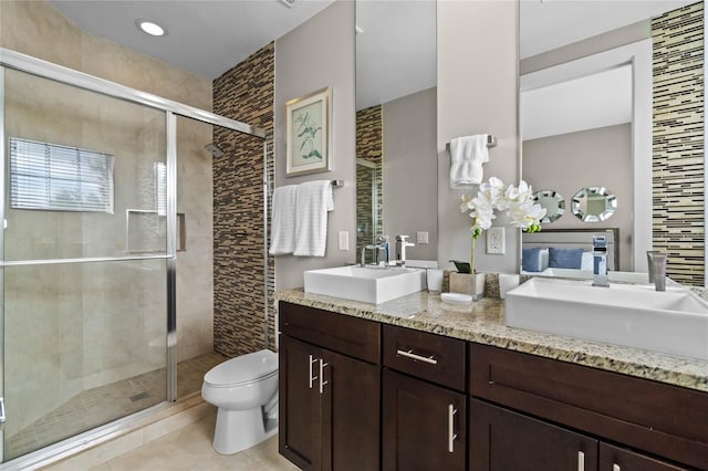 bathroom featuring an enclosed shower, vanity, toilet, and tile patterned flooring