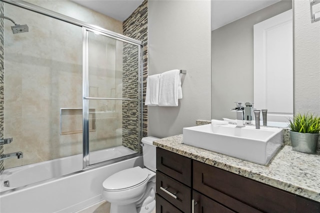 full bathroom featuring vanity, toilet, and enclosed tub / shower combo