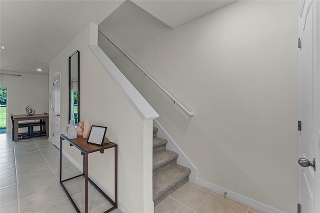 staircase featuring tile patterned floors