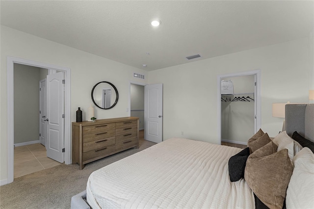 carpeted bedroom featuring a closet and a spacious closet