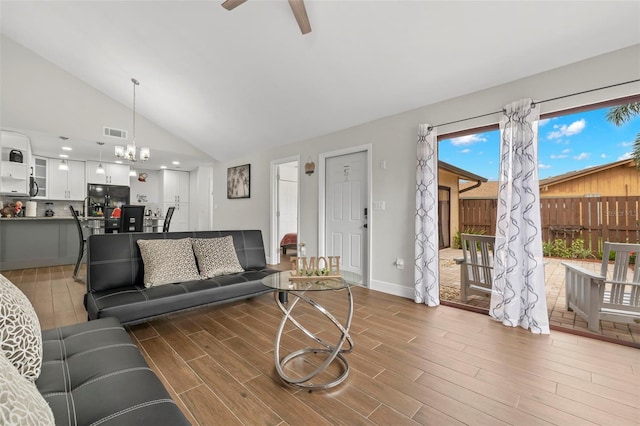 living room featuring a wealth of natural light, high vaulted ceiling, and hardwood / wood-style flooring