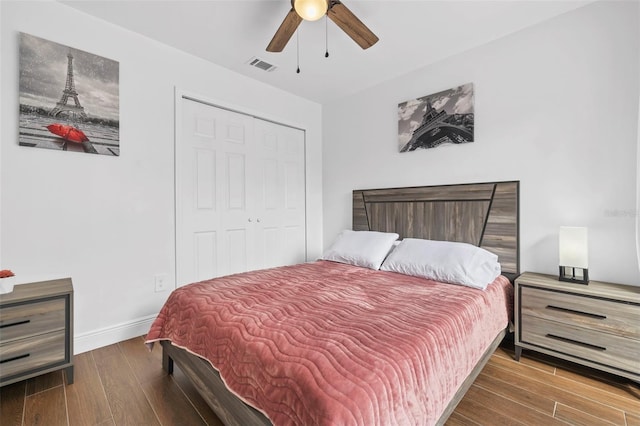 bedroom with ceiling fan, wood-type flooring, and a closet