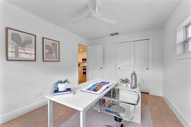 office space with light hardwood / wood-style flooring and ceiling fan