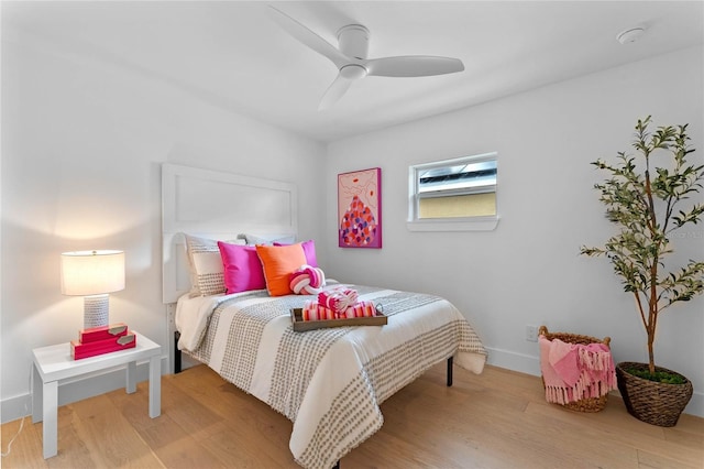 bedroom with light hardwood / wood-style flooring and ceiling fan