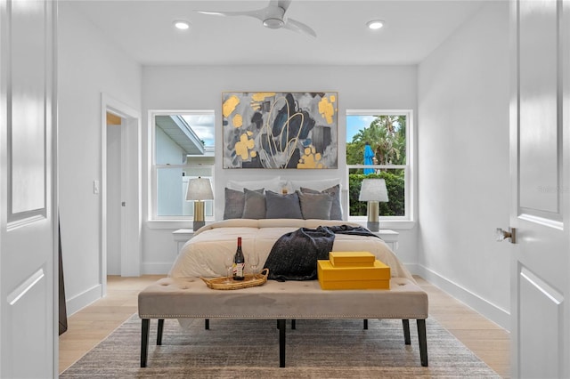 bedroom with ceiling fan and light hardwood / wood-style floors