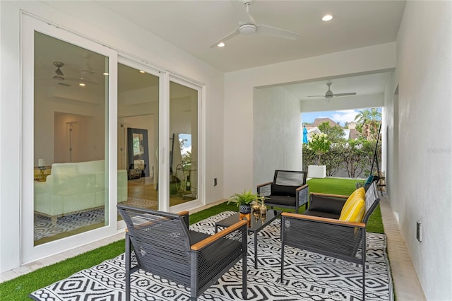 sunroom / solarium featuring ceiling fan