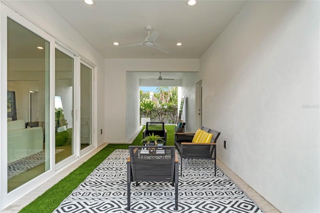 sunroom / solarium featuring ceiling fan