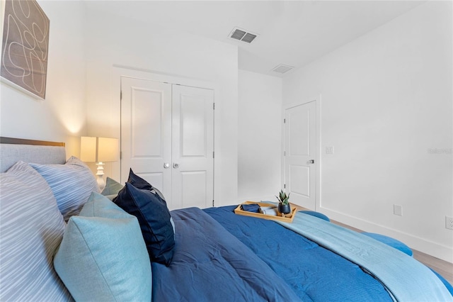 bedroom featuring wood-type flooring and a closet