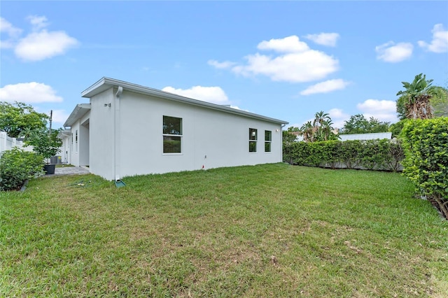 rear view of property featuring a yard