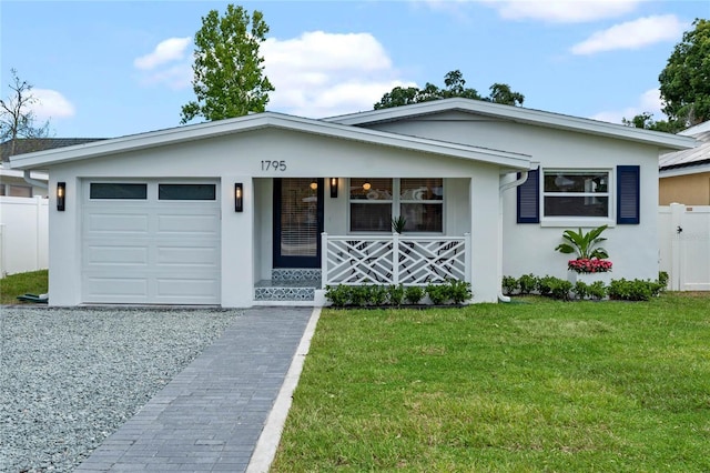 view of front of property with a front yard, a porch, and a garage