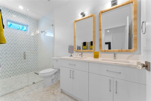 bathroom with vanity, toilet, and a shower