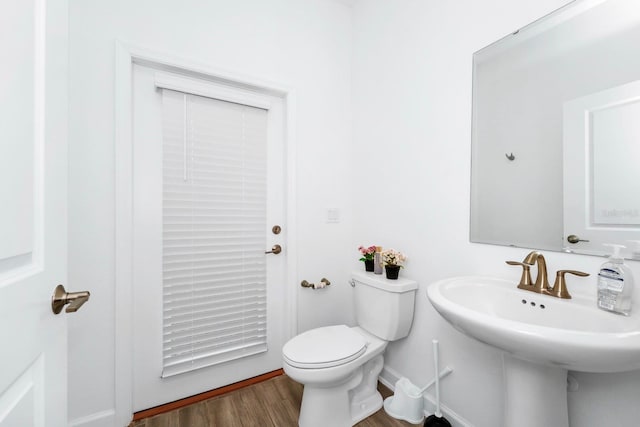 bathroom featuring toilet, hardwood / wood-style flooring, and sink