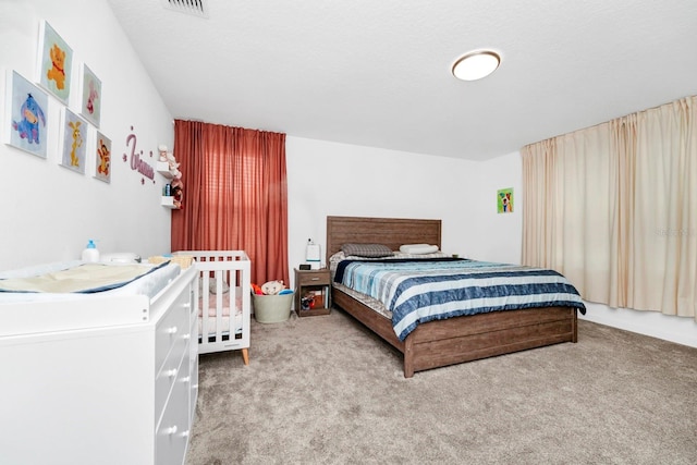 bedroom with a textured ceiling and carpet flooring