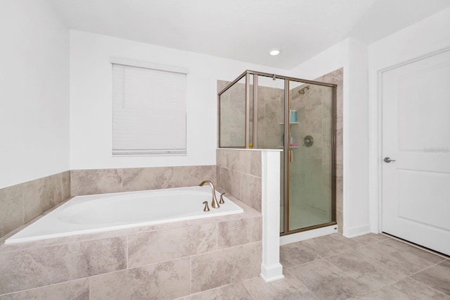 bathroom with independent shower and bath and tile patterned flooring