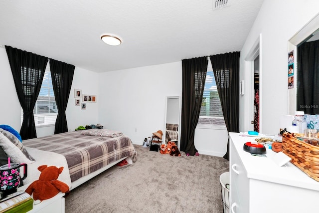 bedroom featuring a textured ceiling and carpet