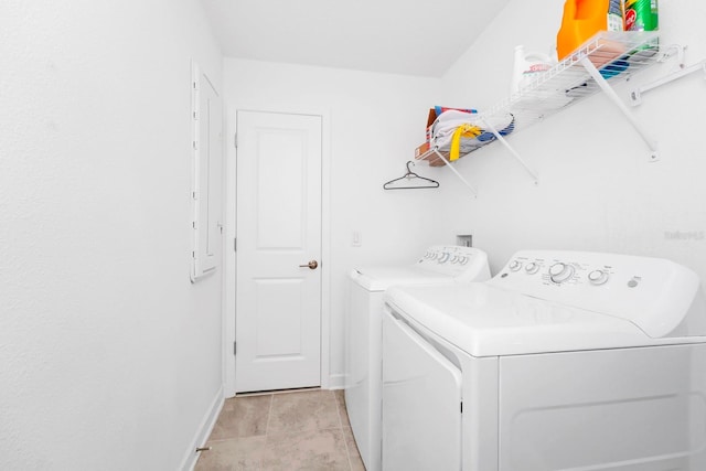 clothes washing area featuring washer and clothes dryer