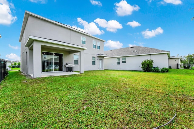 back of property with a patio and a lawn