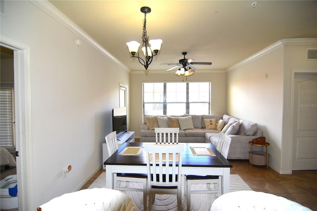 dining space with tile patterned floors, ceiling fan with notable chandelier, and crown molding