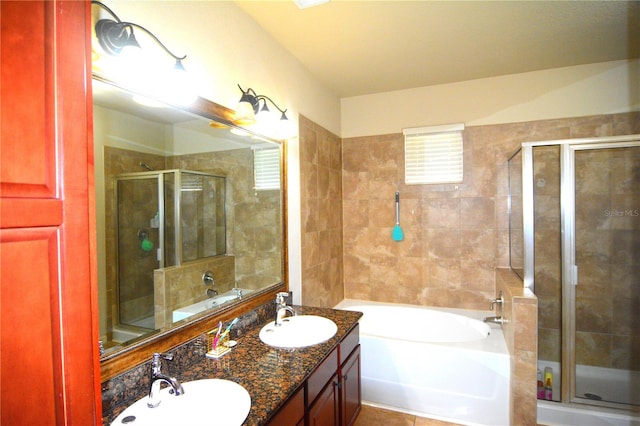 bathroom with vanity and separate shower and tub