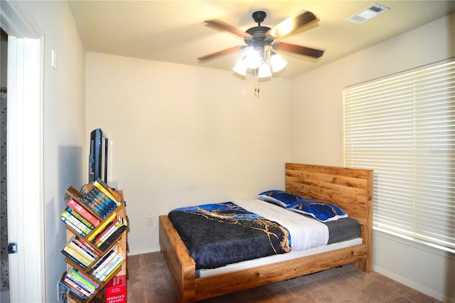 bedroom featuring ceiling fan and carpet