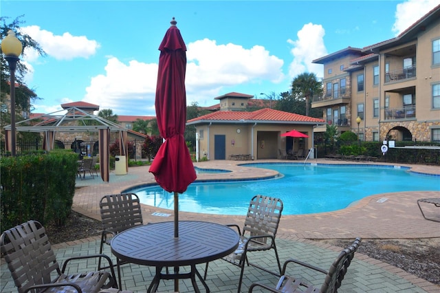 view of pool with a jacuzzi, a gazebo, and a patio