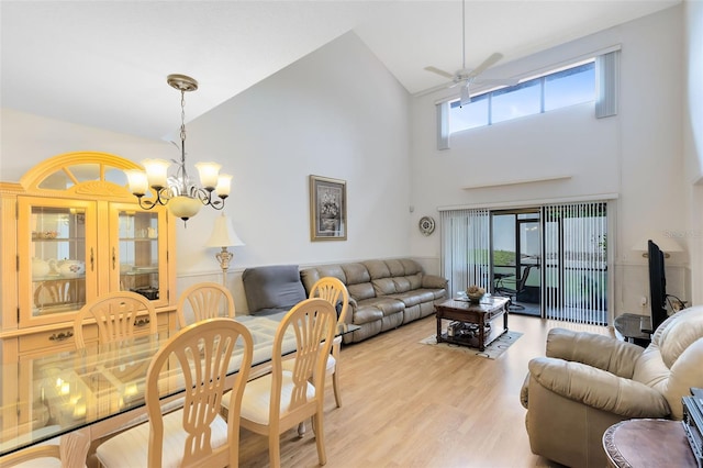 living room featuring high vaulted ceiling, light hardwood / wood-style flooring, and ceiling fan with notable chandelier