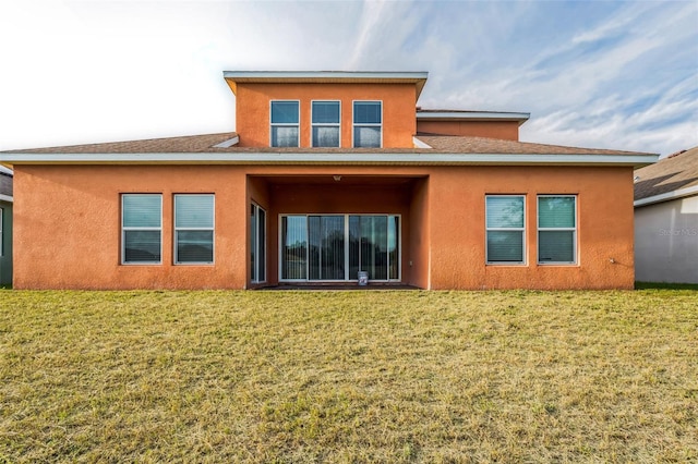 rear view of property with a lawn